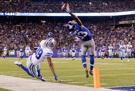 New York Giants wide receiver Odell Beckham Jr. (13) makes a one-handed catch for a touchdown against Dallas Cowboys cornerback Brandon Carr (39) in the second quarter of an NFL football game, Sunday, Nov. 23, 2014, in East Rutherford, N.J. (AP Photo/Julio Cortez)  ORG XMIT: ERU108